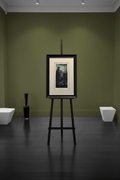Framed artwork on easel with olive green gallery walls